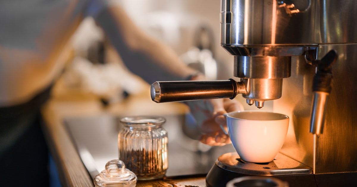 Coffee maker actively brewing a fresh cup of coffee on a kitchen counter